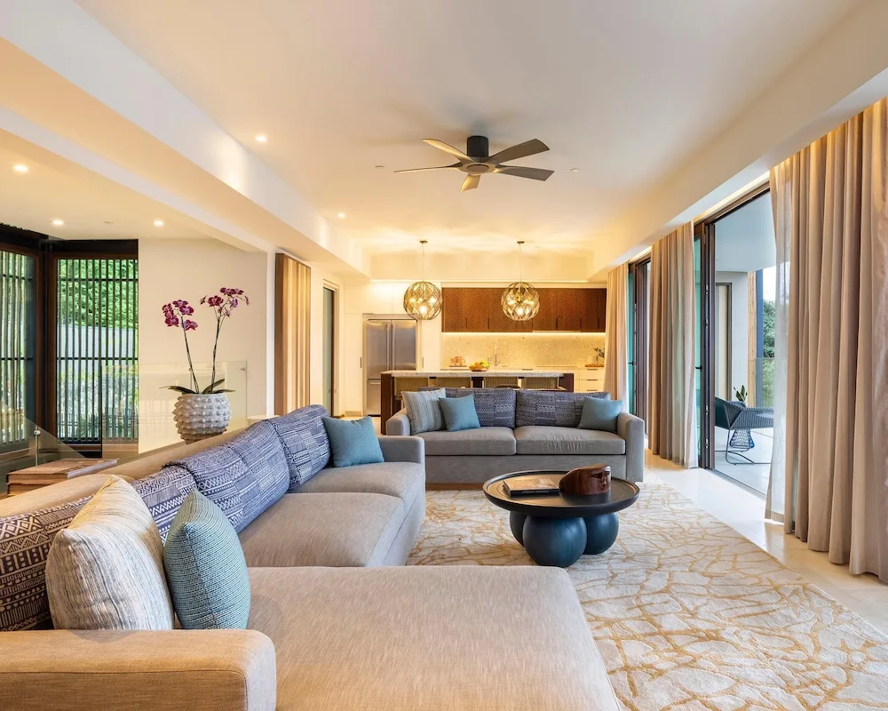 Suite living room with sofas and kitchen at Andaz Peninsula Papagayo Resort, Costa Rica.