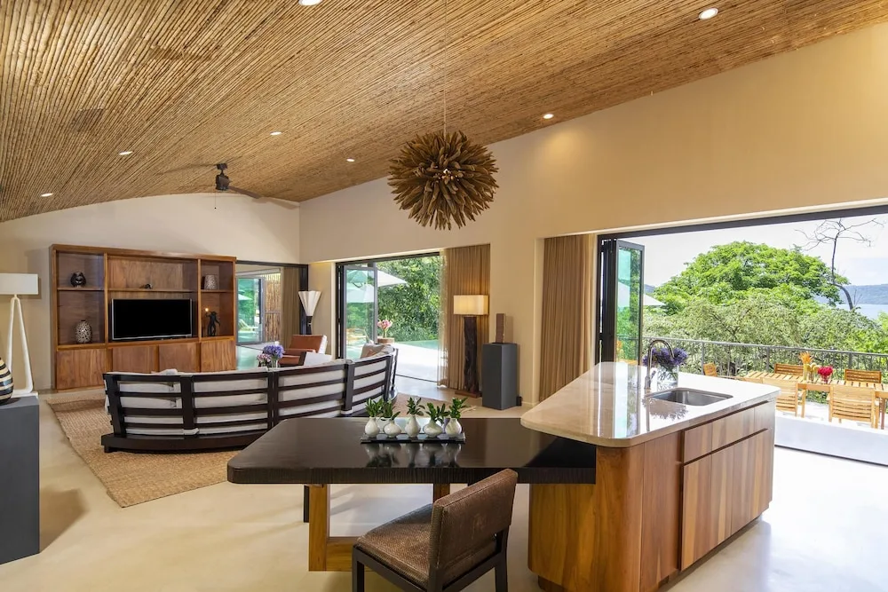 Open villa living room and kitchen at Andaz Peninsula Papagayo Resort, Costa Rica.