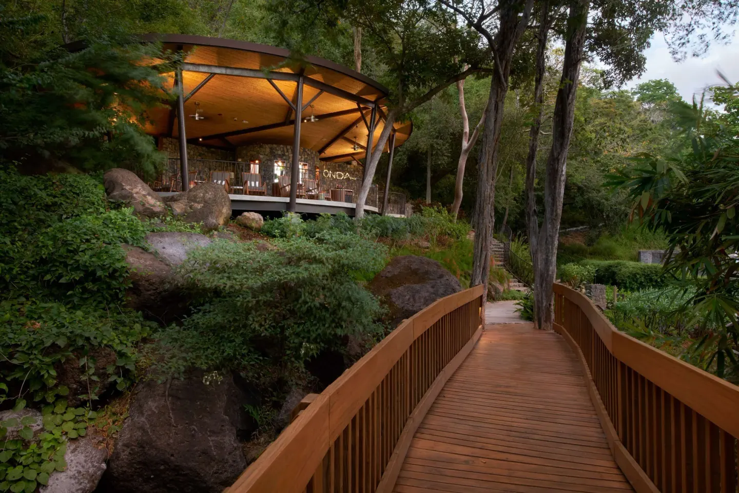 Wooden walkway through landscaped resort grounds at Andaz Peninsula Papagayo Resort, Costa Rica.
