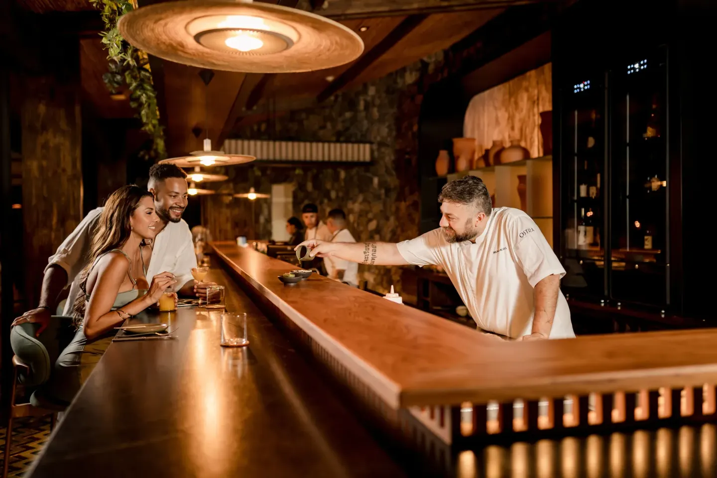 A chef serves guests at a dining counter at Andaz Peninsula Papagayo Resort, Costa Rica.