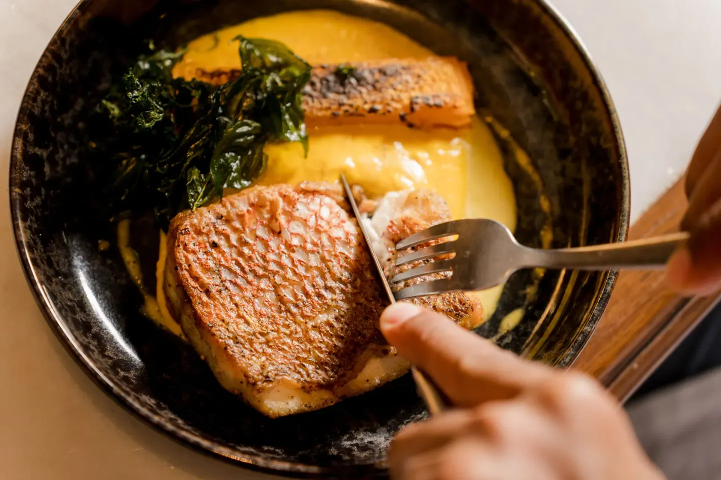 A seafood dish is cut with a fork at Andaz Peninsula Papagayo Resort, Costa Rica.