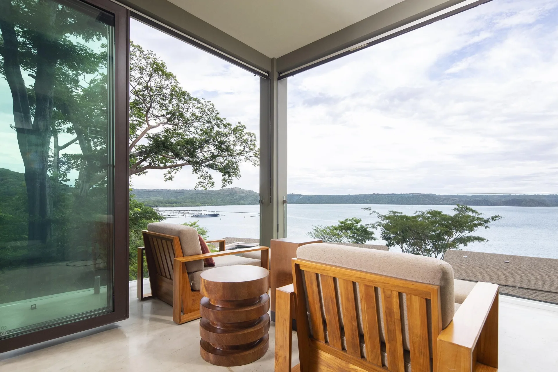Bay view suite terrace with lounge chairs at Andaz Peninsula Papagayo Resort, Costa Rica.