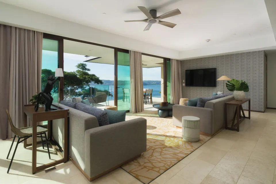 Sofas and sliding glass doors in the 3 Bedroom Penthouse at Andaz Peninsula Papagayo Resort, Costa Rica.