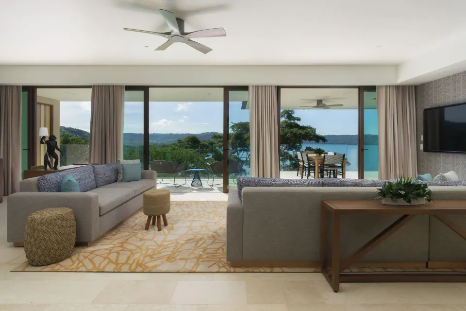 Living room and terrace view in the 3 Bedroom Penthouse at Andaz Peninsula Papagayo Resort, Costa Rica.