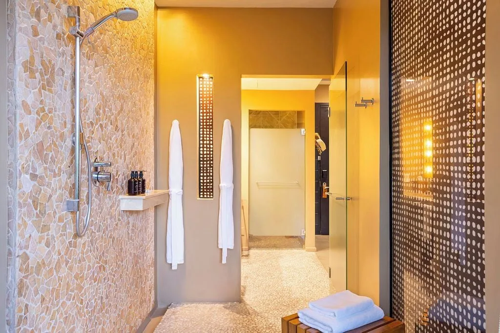 Bay View room bathroom with open shower and robes at Andaz Peninsula Papagayo Resort, Costa Rica.