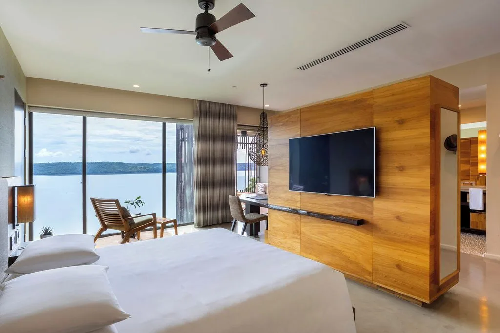 Bay View guest room with king bed, TV wall and balcony view at Andaz Peninsula Papagayo Resort, Costa Rica.