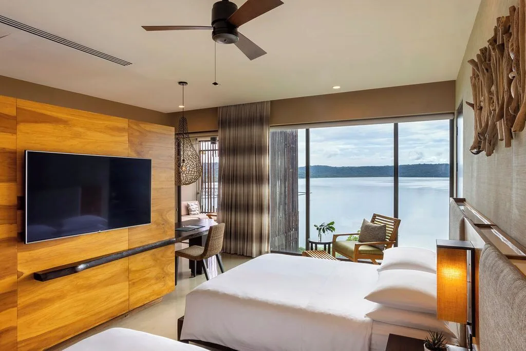 Bay View guest room with king bed and water view at Andaz Peninsula Papagayo Resort, Costa Rica.