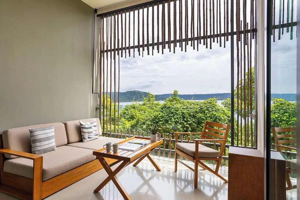 Indoor lounge area with partial bay view at Andaz Peninsula Papagayo Resort, Costa Rica.