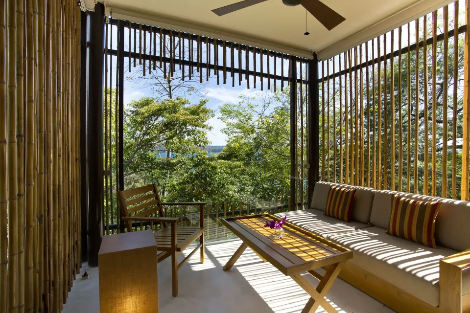 Screened terrace seating with bay glimpses at Andaz Peninsula Papagayo Resort, Costa Rica.