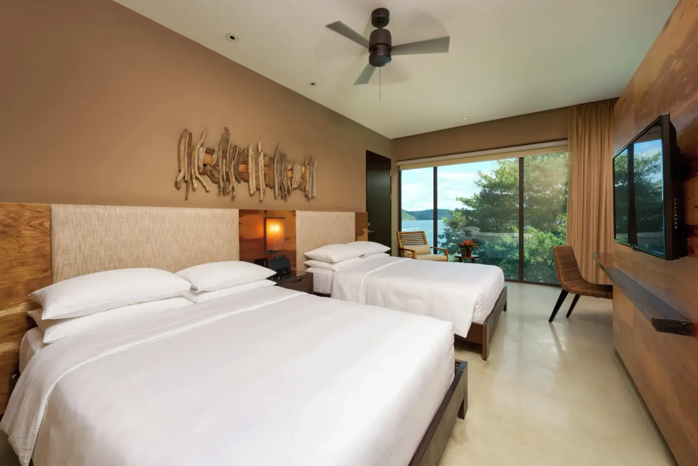 Two-bed guest room with partial bay view at Andaz Peninsula Papagayo Resort, Costa Rica.