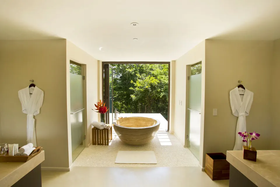 Suite bathroom with soaking tub and garden view at Andaz Peninsula Papagayo Resort, Costa Rica.