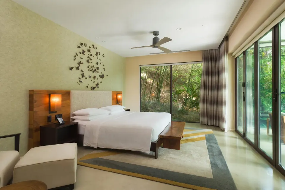 King bedroom with garden-facing windows at Andaz Peninsula Papagayo Resort, Costa Rica.