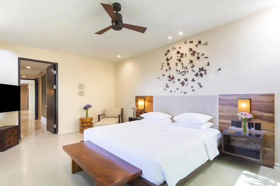Suite bedroom with king bed and wall art at Andaz Peninsula Papagayo Resort, Costa Rica.