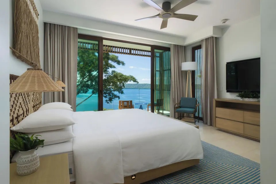 King villa bedroom with bay view windows at Andaz Peninsula Papagayo Resort, Costa Rica.