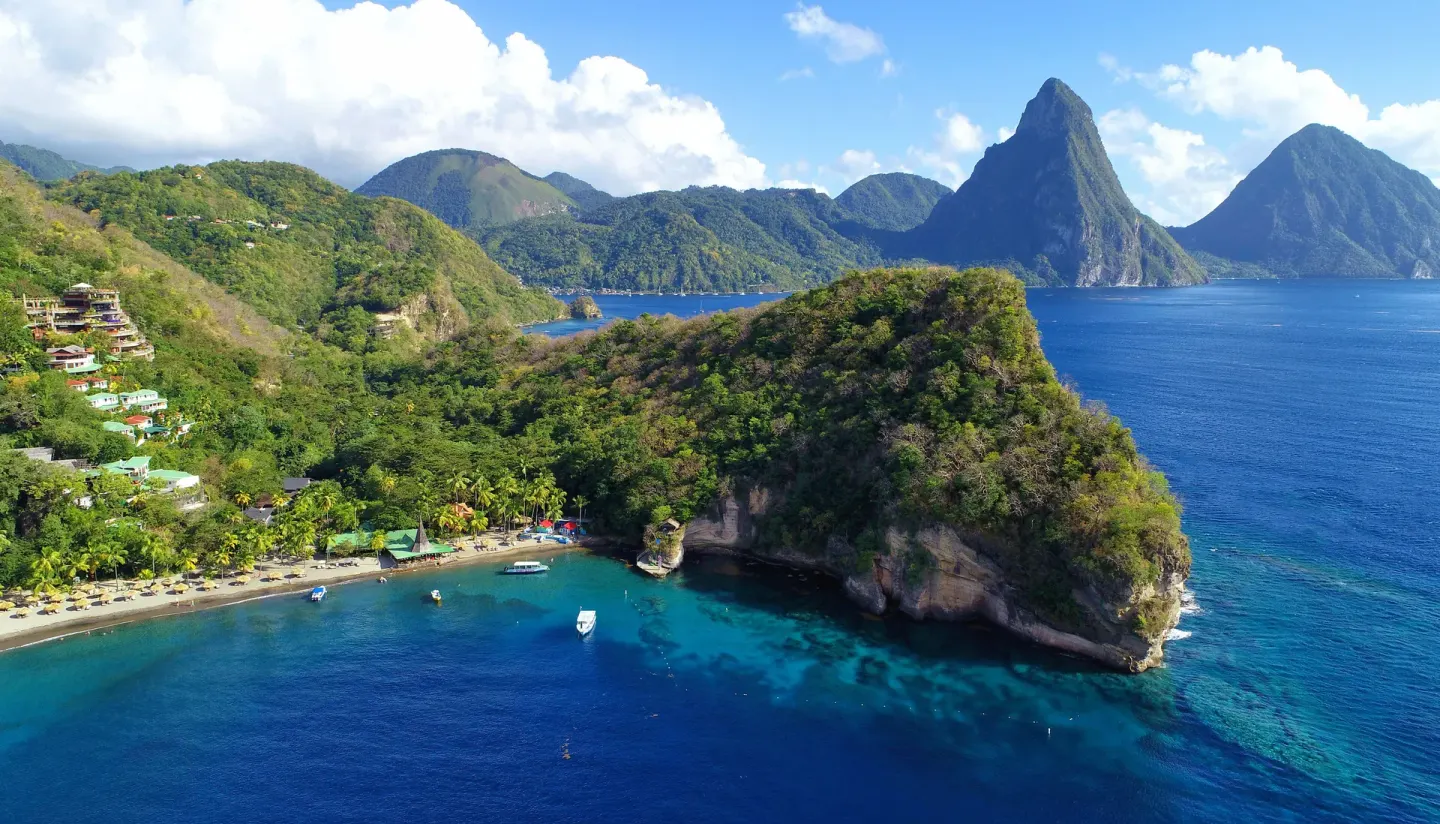 Aerial view of Anse Chastanet Resort coastline with the Pitons beyond.