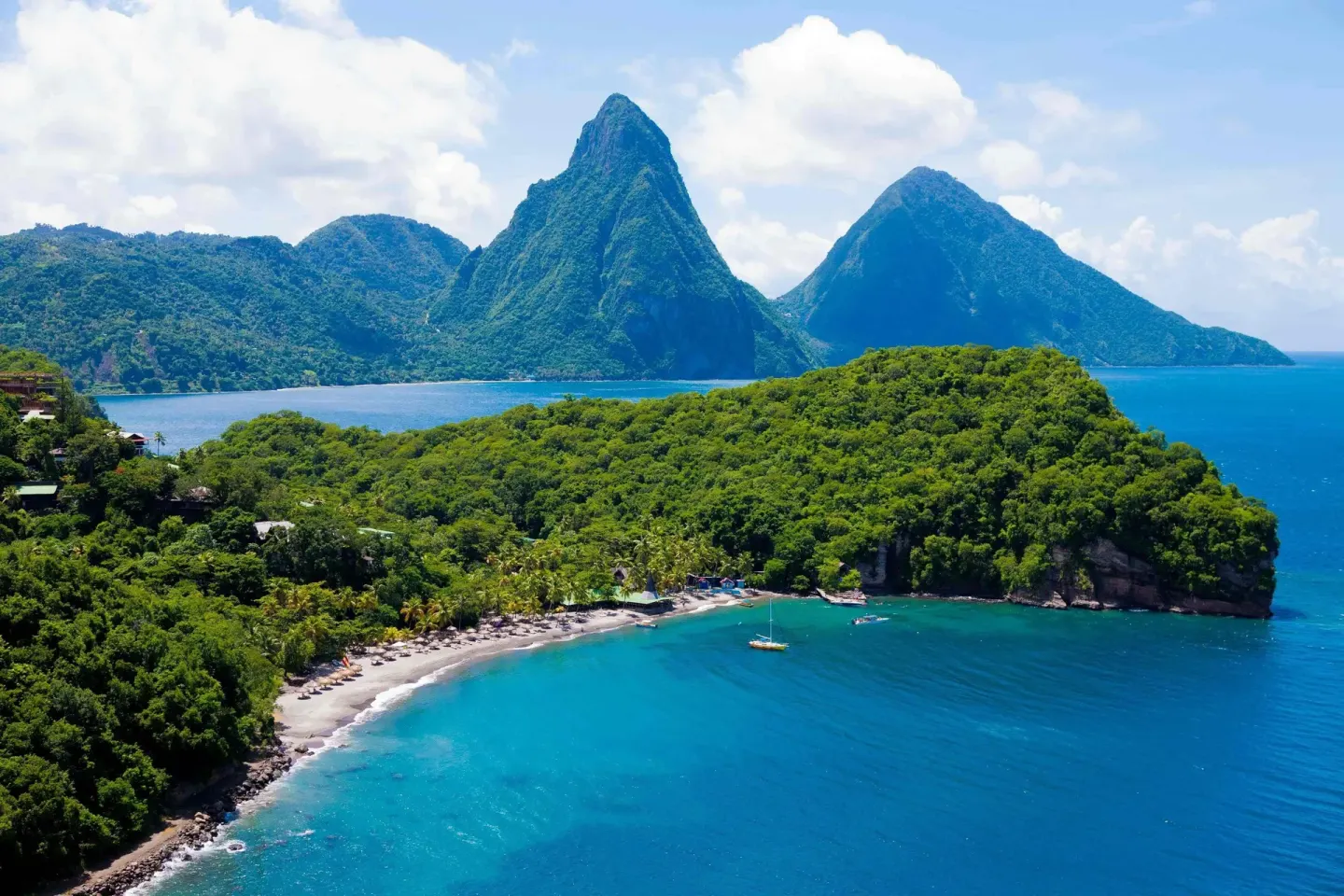 Aerial view from Anse Chastanet Resort toward the Pitons, forested coastline, and blue bay.