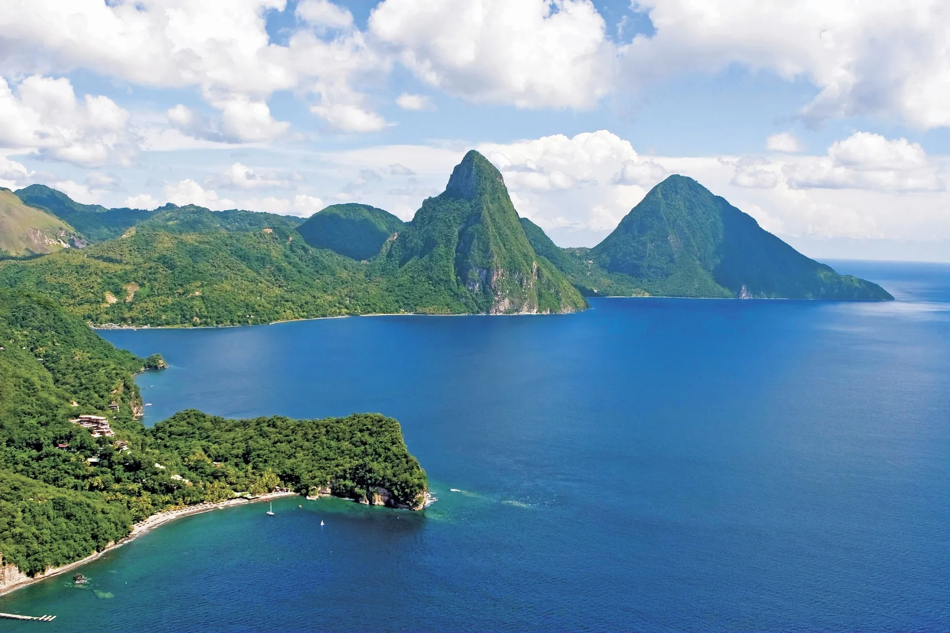 Aerial view of the Pitons, coastline, and blue Caribbean Sea near Anse Chastanet Resort.