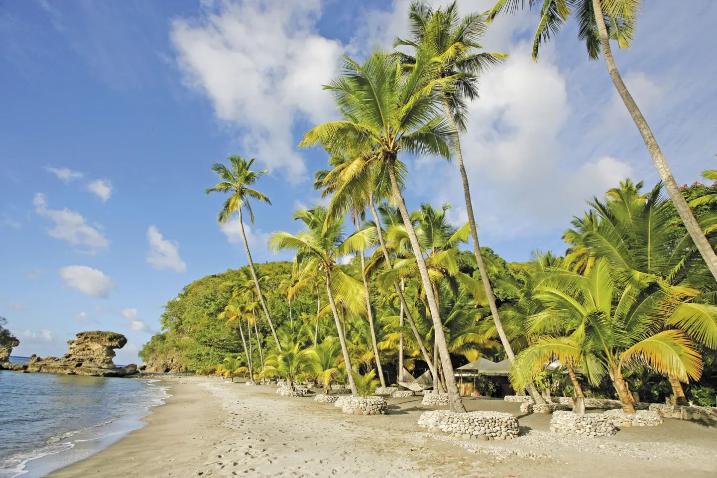 Palm trees and a sandy shoreline frame the water at Anse Chastanet Resort.