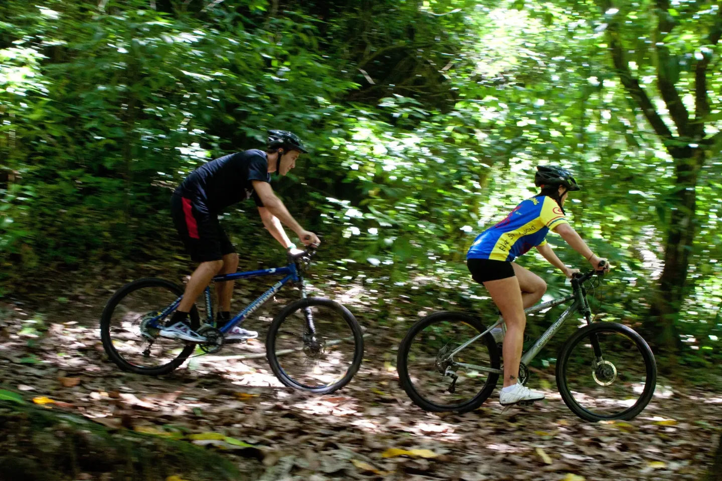 Two cyclists ride along a wooded trail at Anse Chastanet Resort.