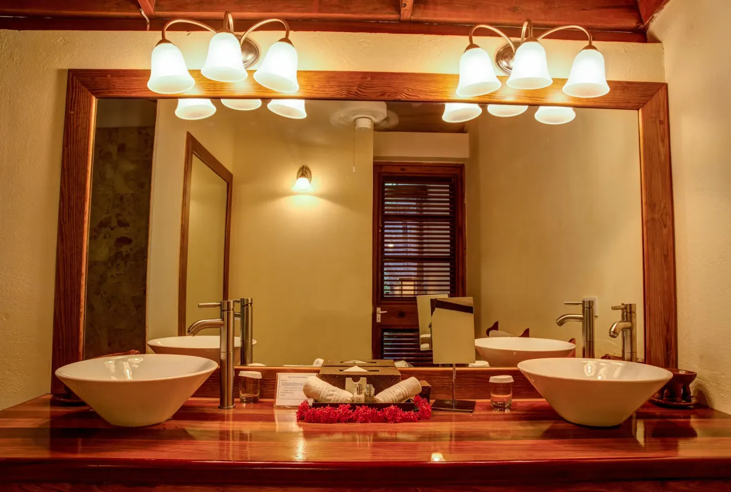 Deluxe Beachside Room bathroom with twin vessel sinks and wood vanity at Anse Chastanet Resort.