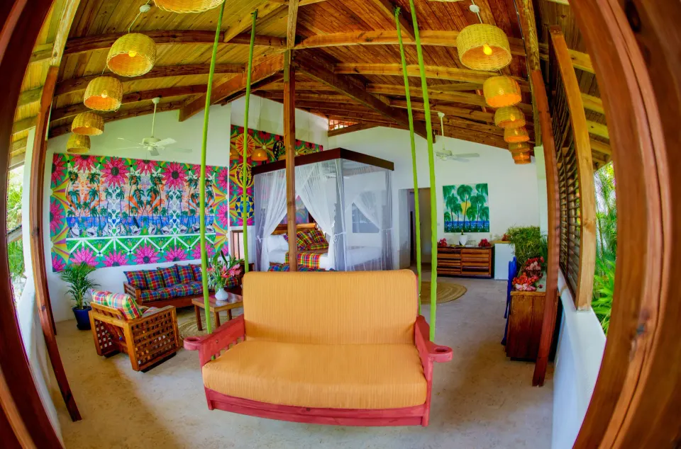 Hillside Deluxe Oceanview room with four-poster bed and sitting area at Anse Chastanet Resort.