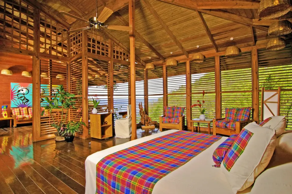 Hillside Deluxe Oceanview room with king bed and wood shutters at Anse Chastanet Resort.