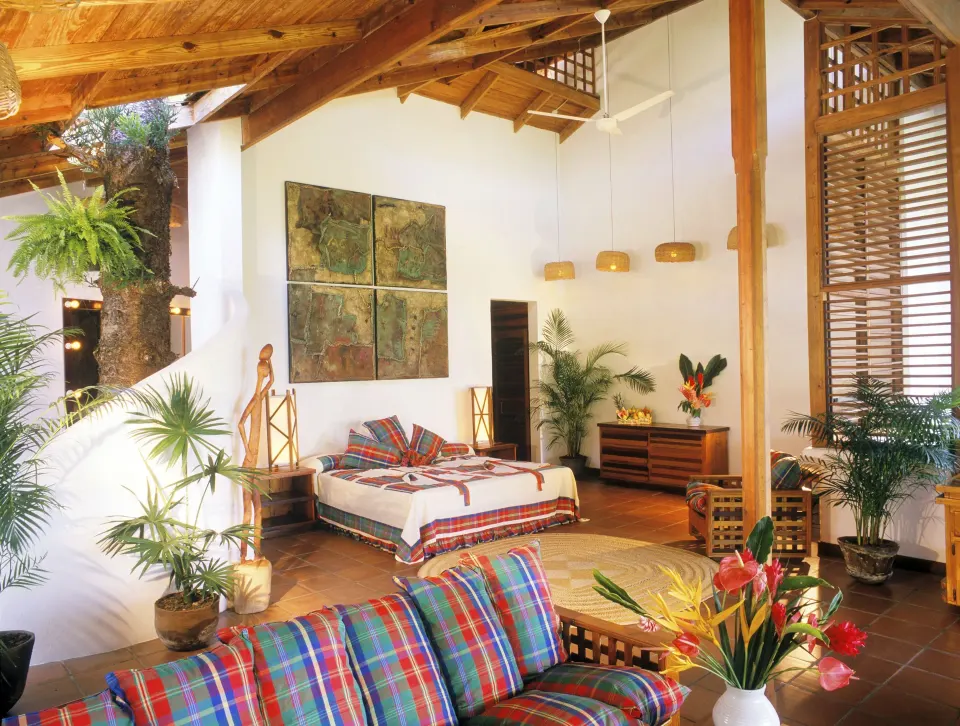 Hillside Deluxe Oceanview room with bed, lounge seating and tropical plants at Anse Chastanet Resort.