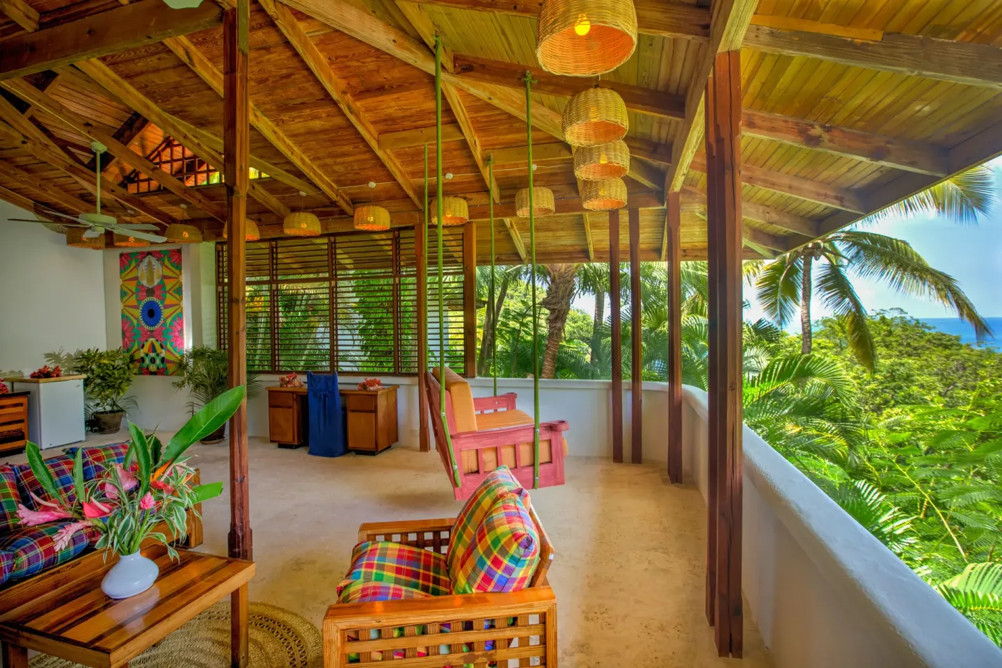 Hillside Deluxe Oceanview terrace lounge with ocean and palms at Anse Chastanet Resort.