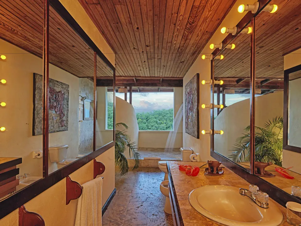 Premium Room bathroom with vanity, mirrors and open view at Anse Chastanet Resort.