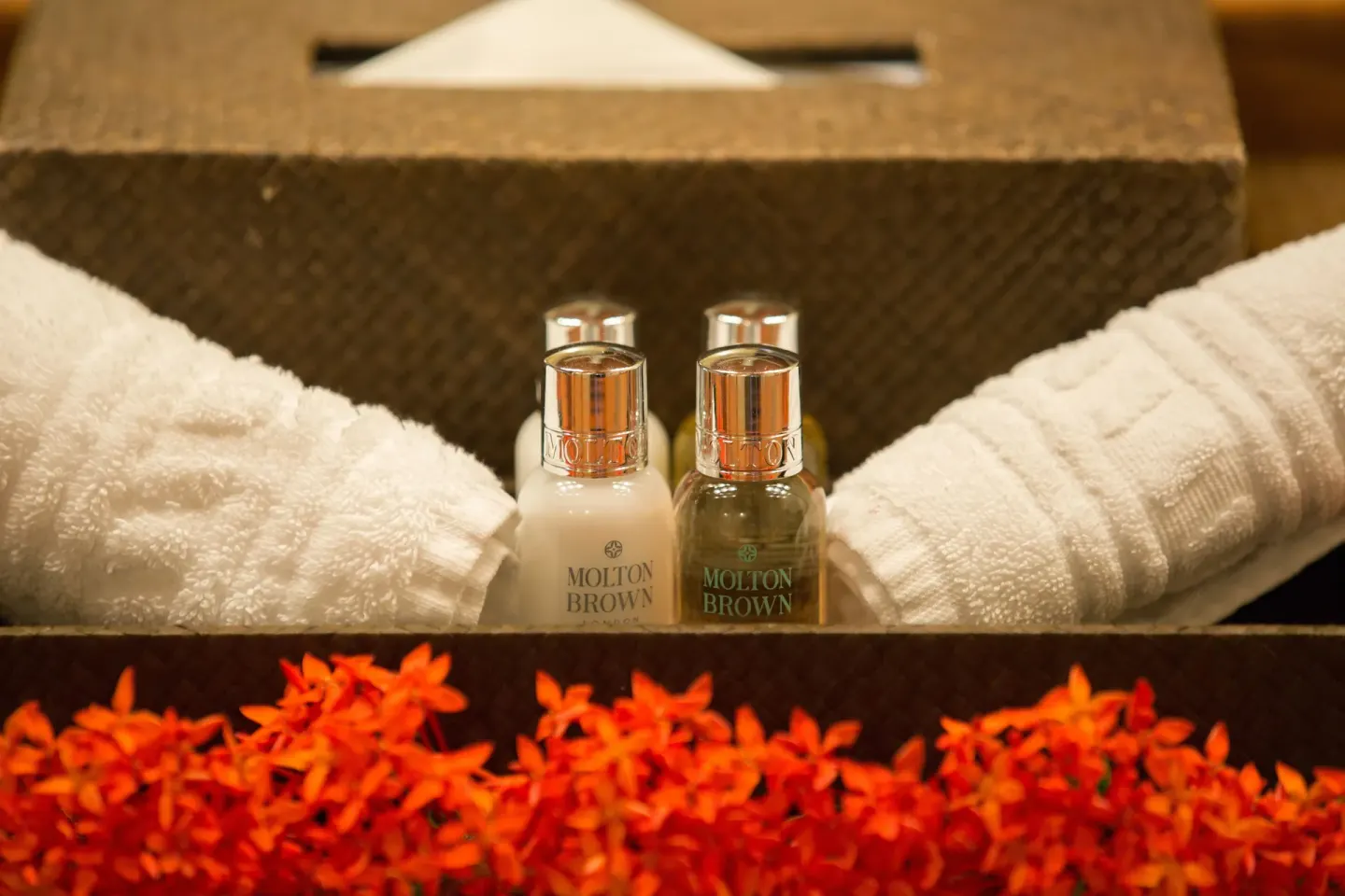Standard Room towels, bath amenities, tissue box and orange flowers at Anse Chastanet Resort.