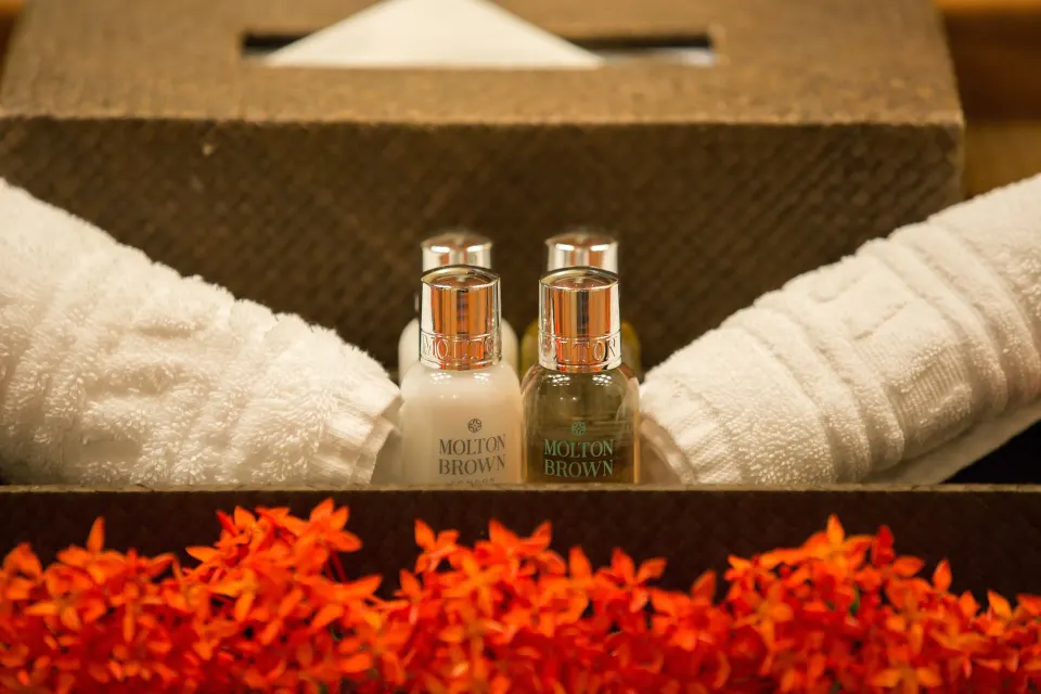 Standard Room towels, bath amenities, tissue box and orange flowers at Anse Chastanet Resort.