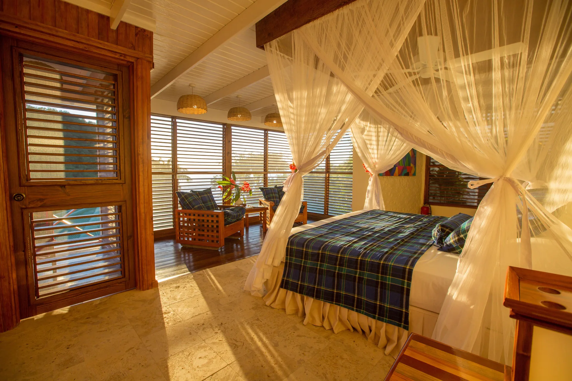 Standard Room with net-draped bed and shuttered sitting area at Anse Chastanet Resort.