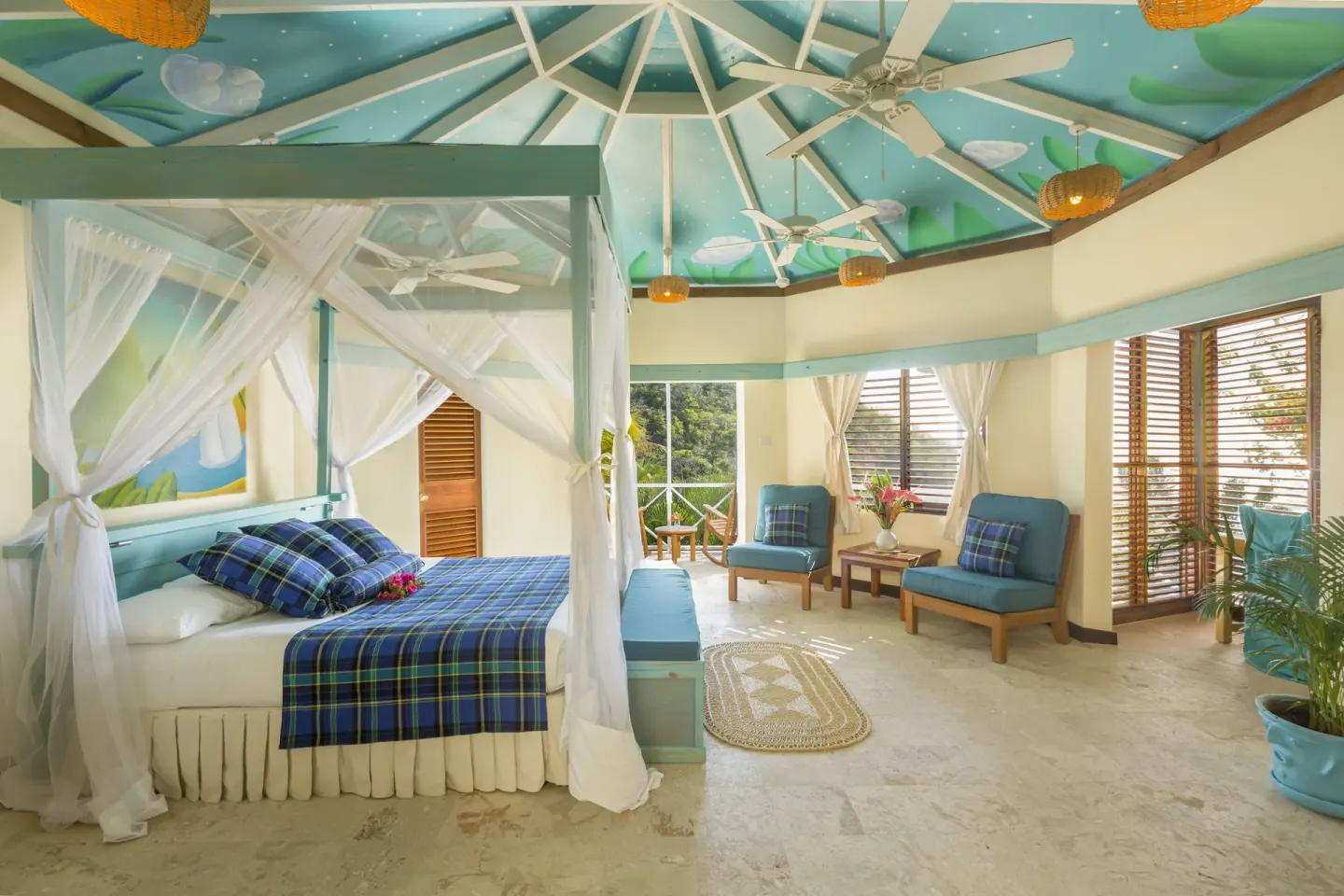 Superior Room Ocean View with bed, lounge chairs and louvered windows at Anse Chastanet Resort.