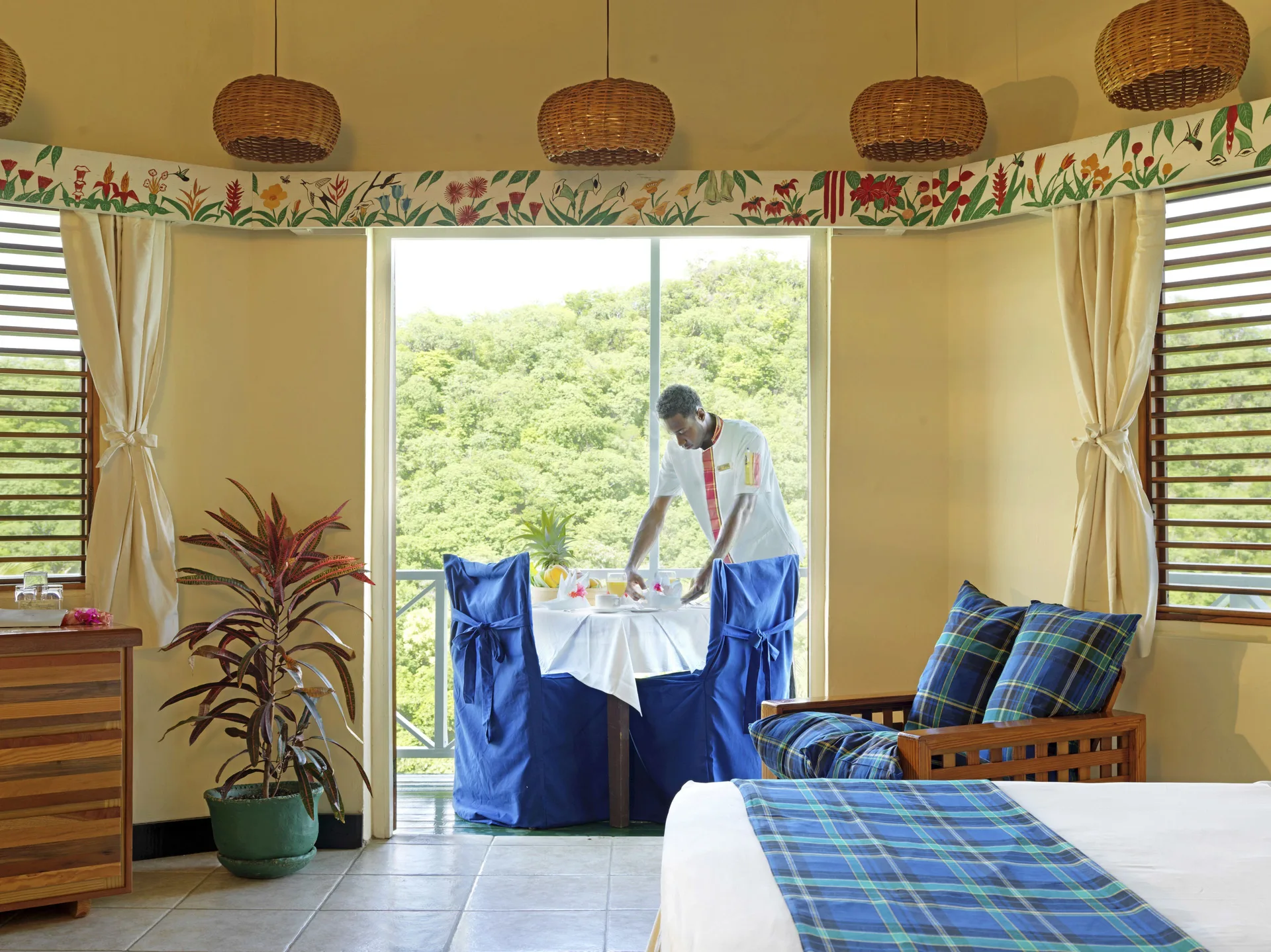 Superior Room Ocean View with bed and balcony dining setup at Anse Chastanet Resort.