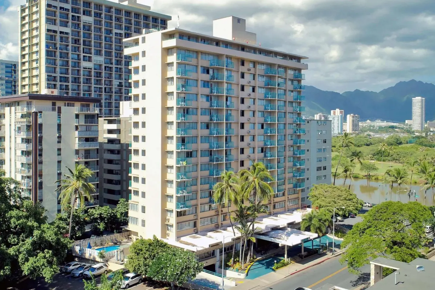 Exterior tower with balconies and mountain backdrop at Aqua Aloha Surf Waikiki.