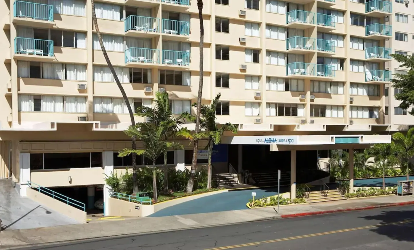 Hotel exterior with balconies and entrance awning at Aqua Aloha Surf Waikiki.