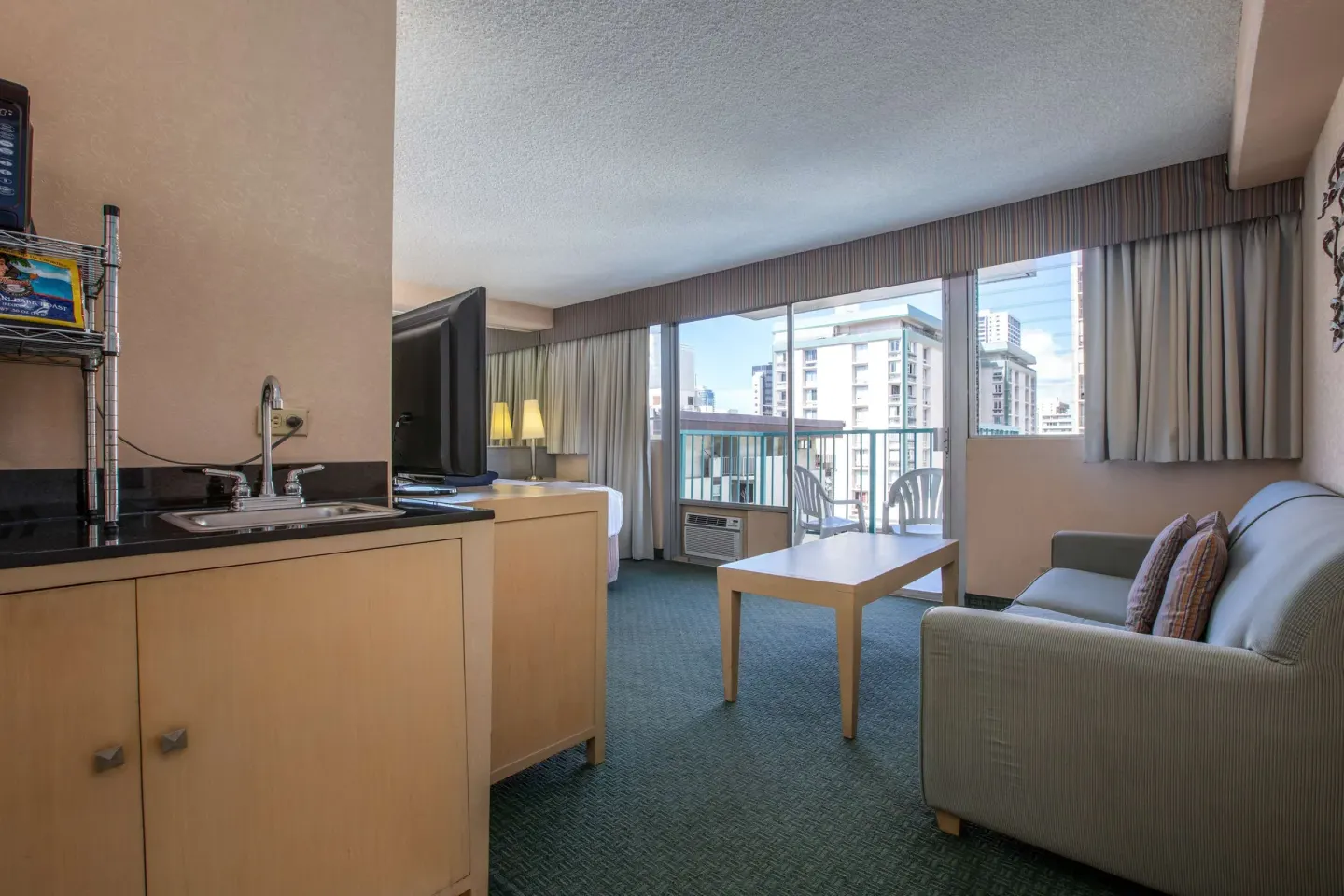 Deluxe Room kitchenette and sitting area at Aqua Aloha Surf Waikiki.