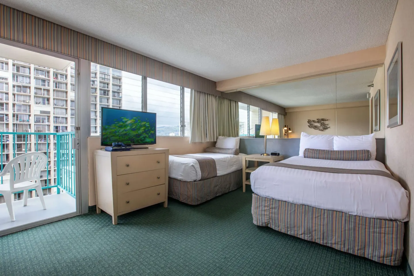 Deluxe Room with two beds, TV, and balcony at Aqua Aloha Surf Waikiki.