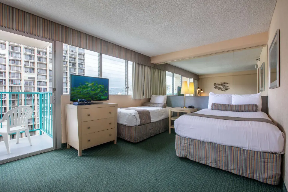 Deluxe Room with two beds, TV, and balcony at Aqua Aloha Surf Waikiki.
