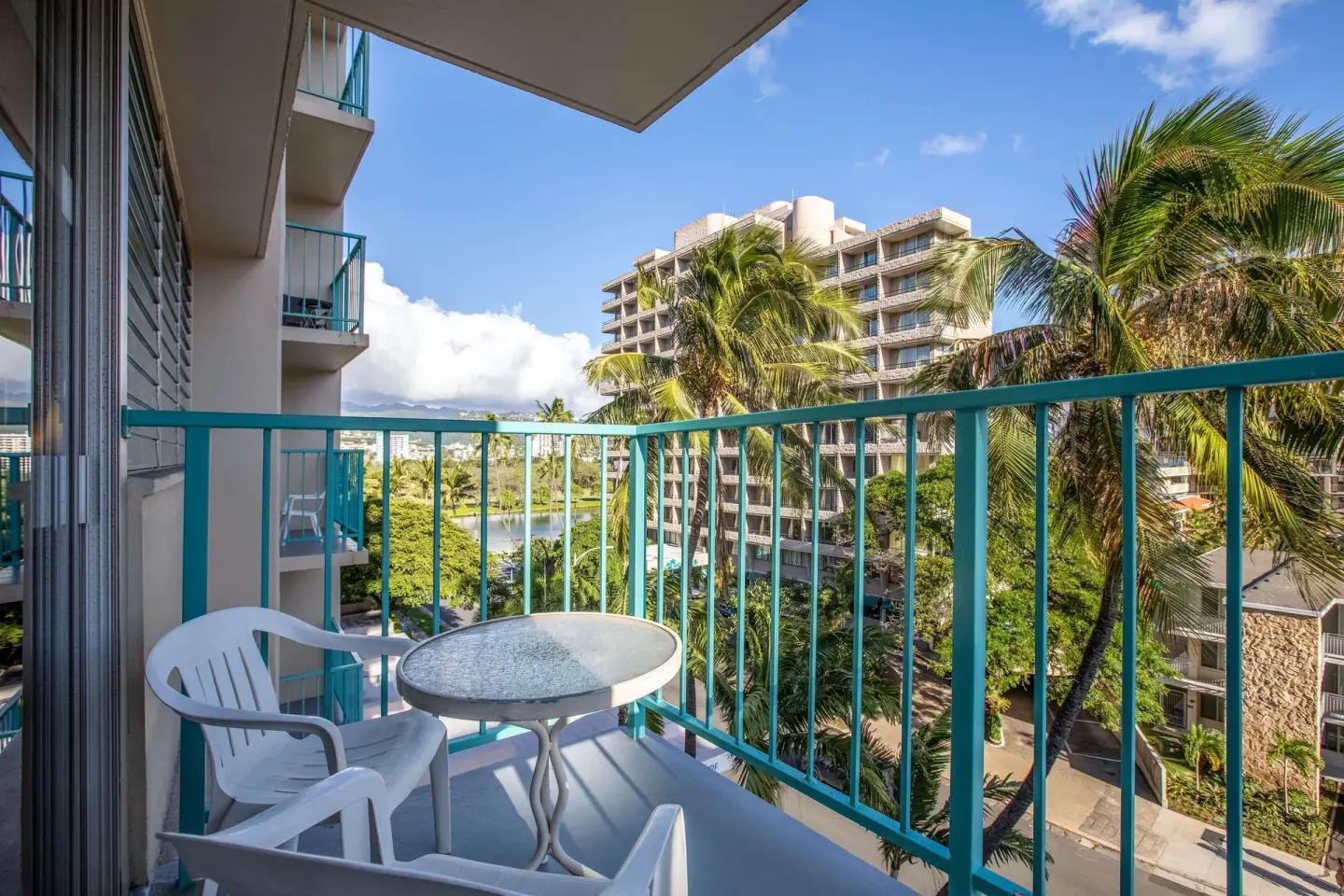 Superior Room balcony with chairs and city views at Aqua Aloha Surf Waikiki.