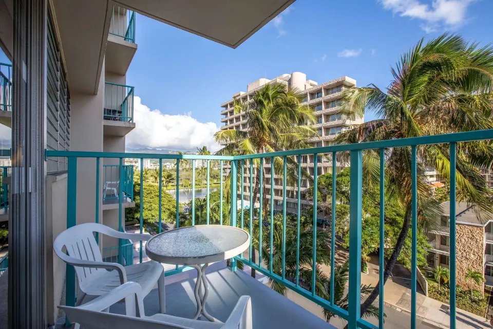 Superior Room balcony with chairs and city views at Aqua Aloha Surf Waikiki.