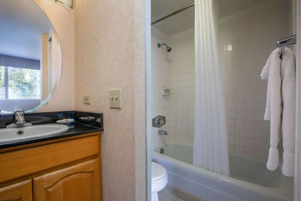Superior Room bathroom vanity and tub shower at Aqua Aloha Surf Waikiki.