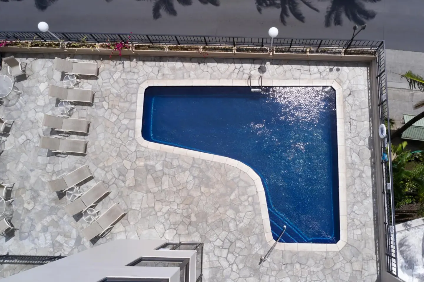 Overhead view of the pool deck and lounge chairs at Aqua Palms Waikiki.