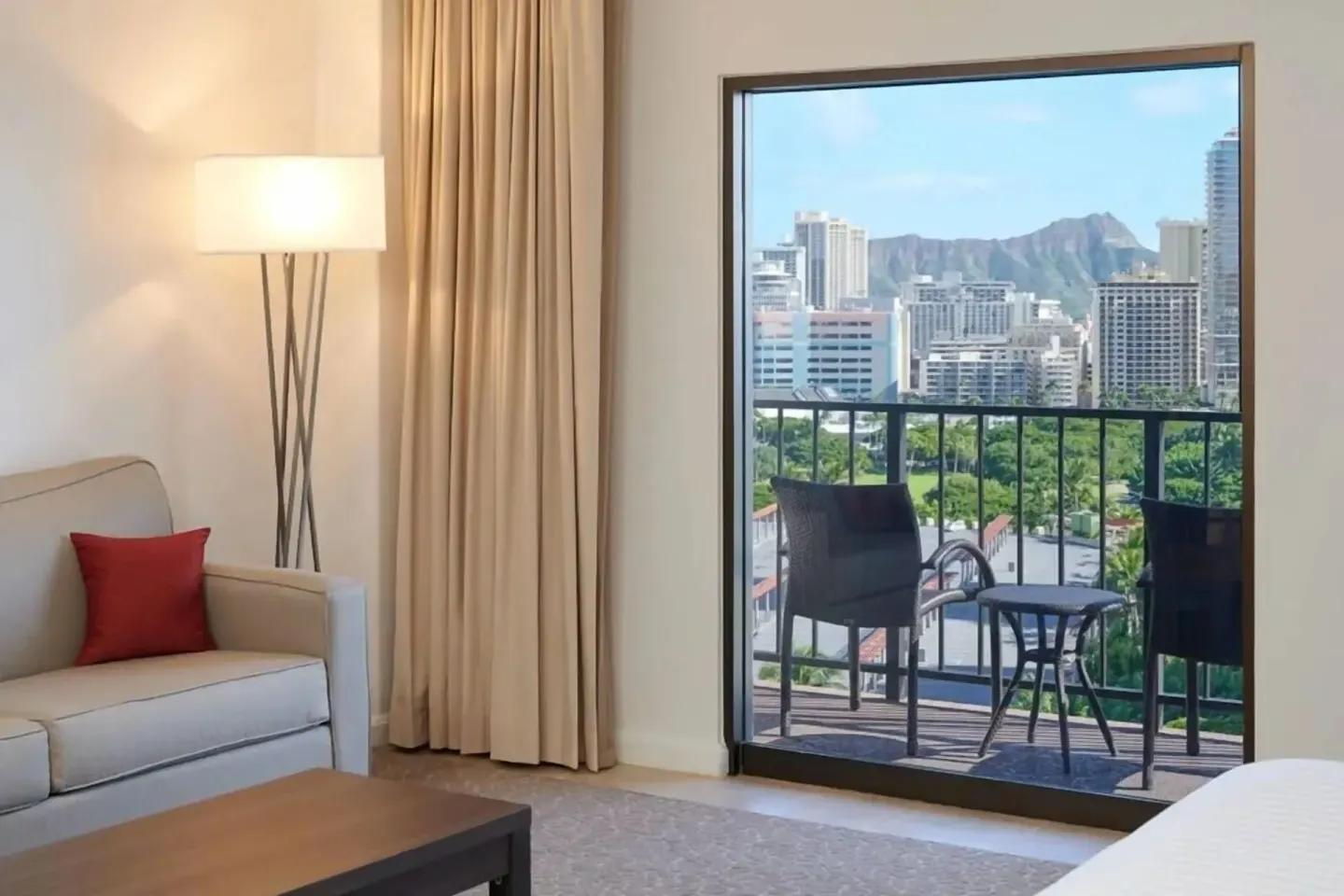 Junior Suite sitting area and balcony city view at Aqua Palms Waikiki.