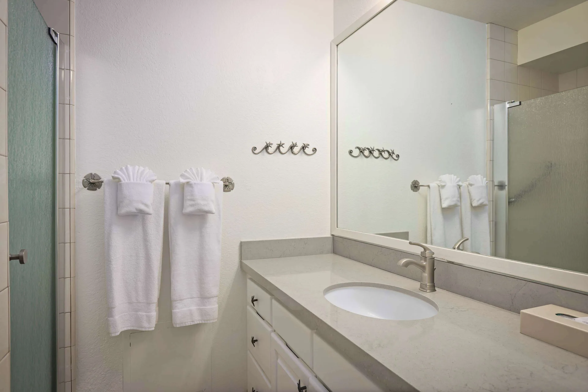 Bathroom vanity and shower at Aston at Poipu Kai with contemporary design and tile work in Poipu Beach, Kauai.