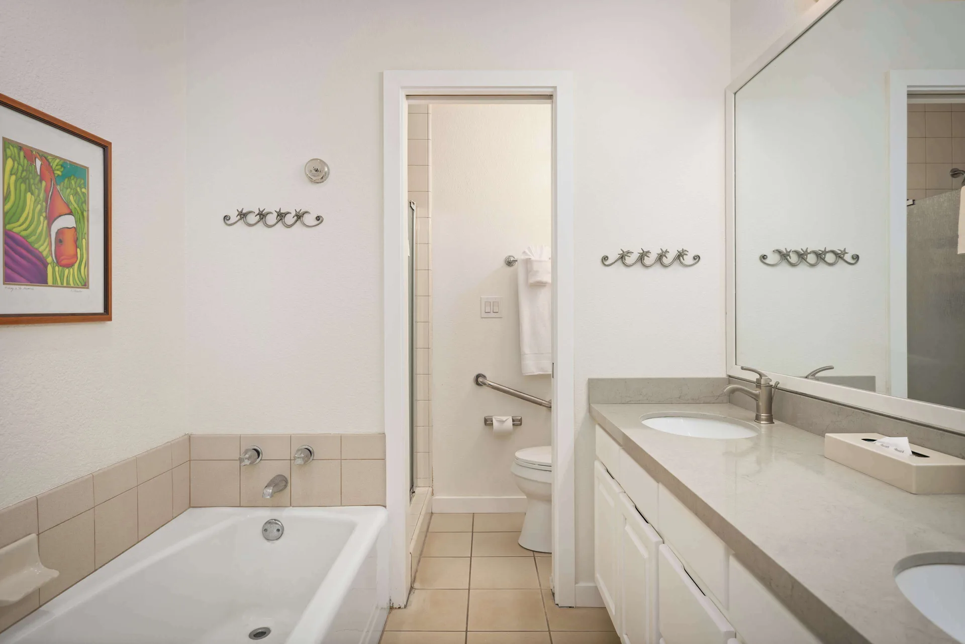 Bathroom with tub and vanity at Aston at Poipu Kai featuring modern fixtures and tile design in Poipu Beach, Kauai.