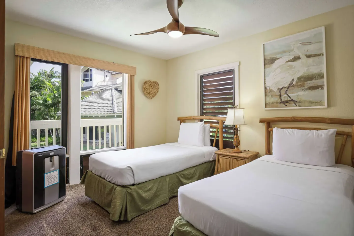 Twin bedroom with balcony window, purifier, and bird artwork at Aston at Poipu Kai.