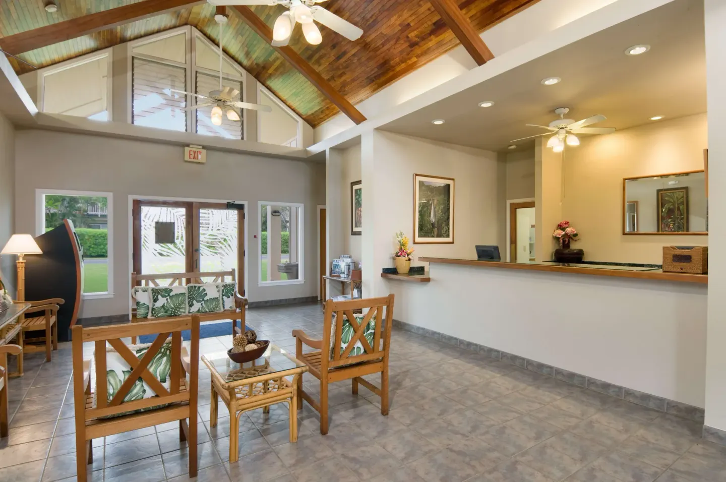 Lobby seating and front desk beneath a wood ceiling at Aston at Poipu Kai.