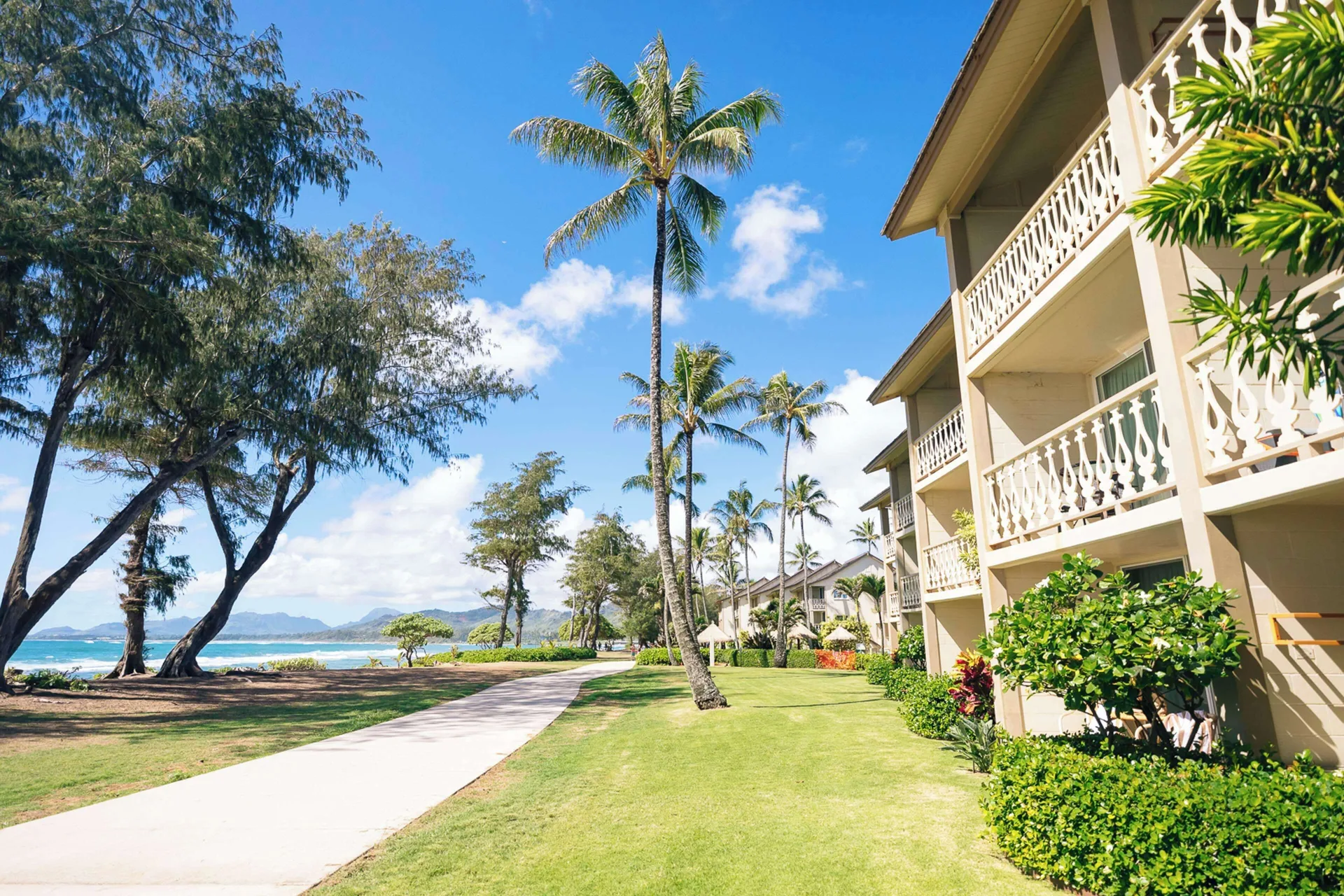 Beachside walkway and guest room balconies at Aston Islander on the Beach.