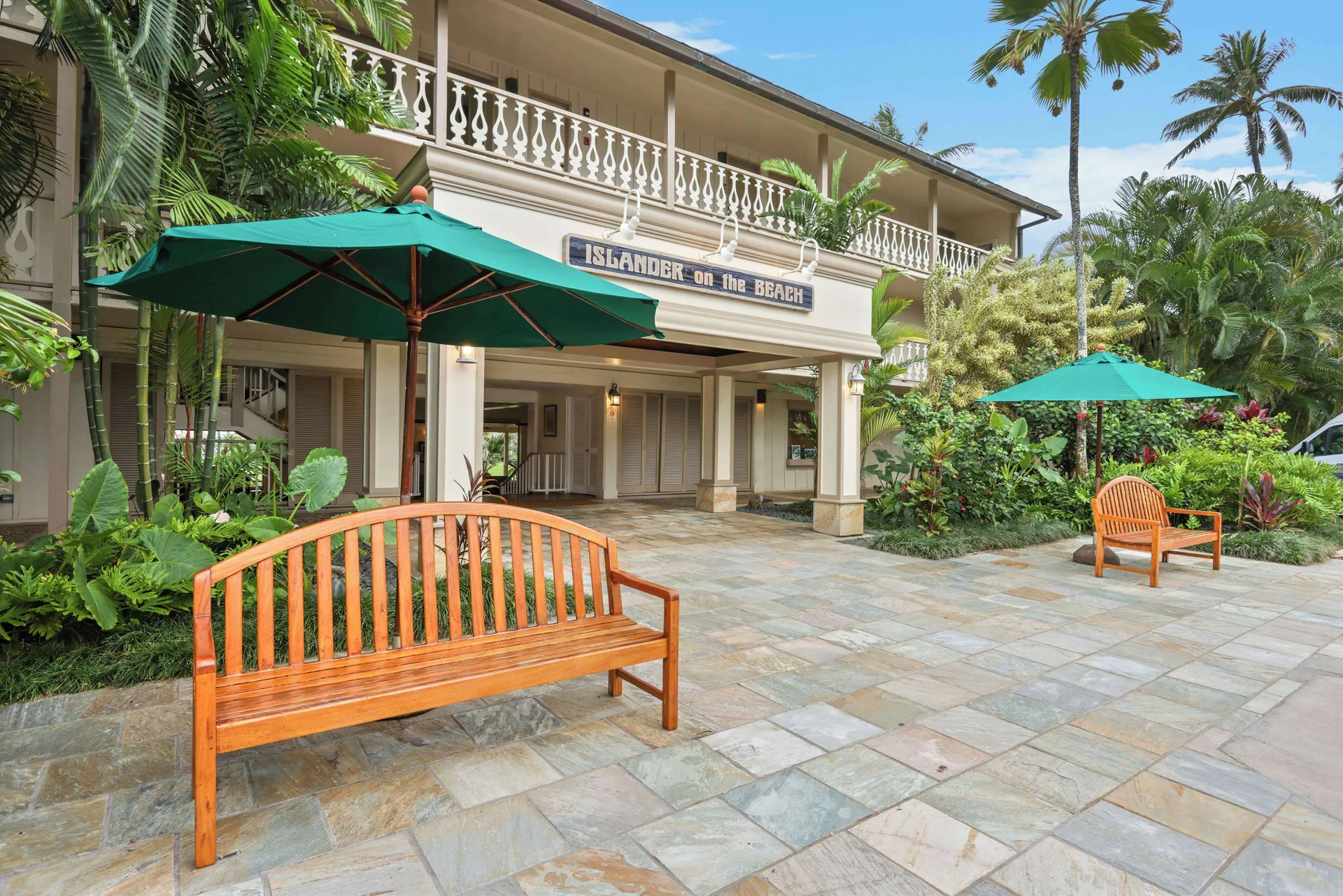Entrance courtyard with benches and umbrellas at Aston Islander on the Beach.